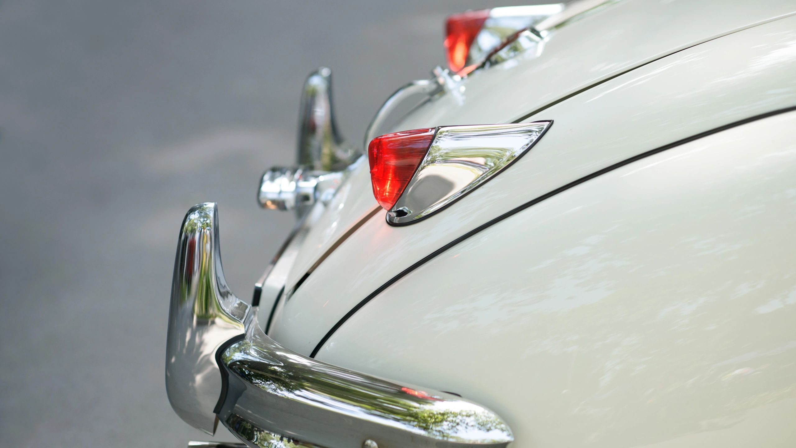 Vintage car tail light and chrome bumper detail