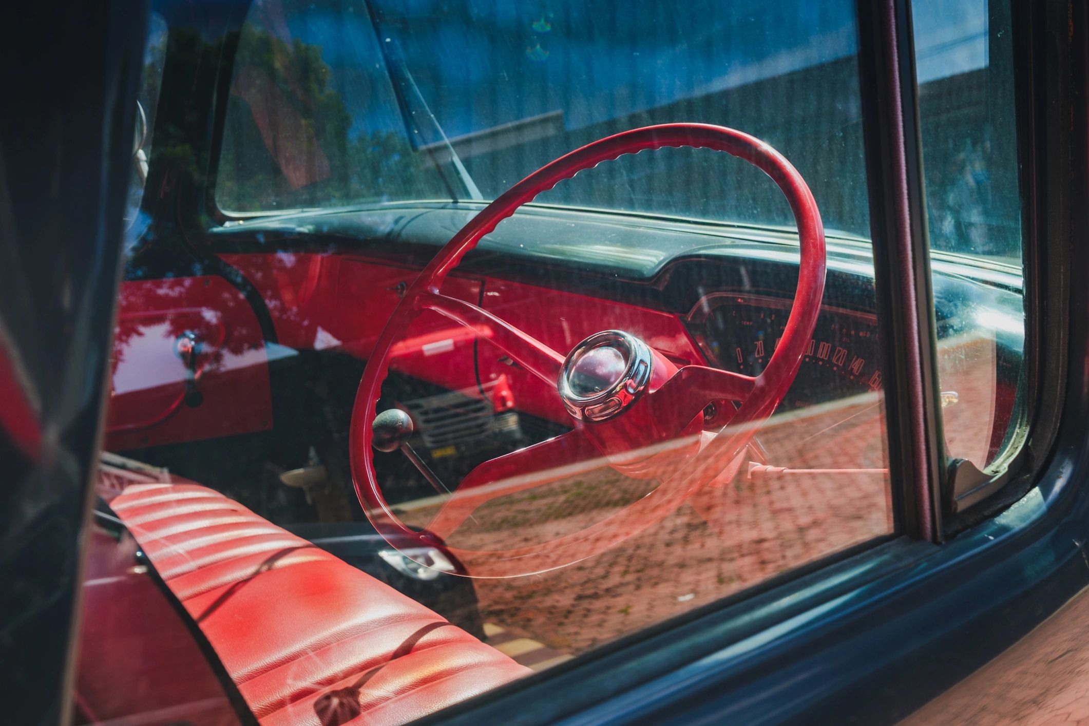 Vintage car interior with red steering wheel