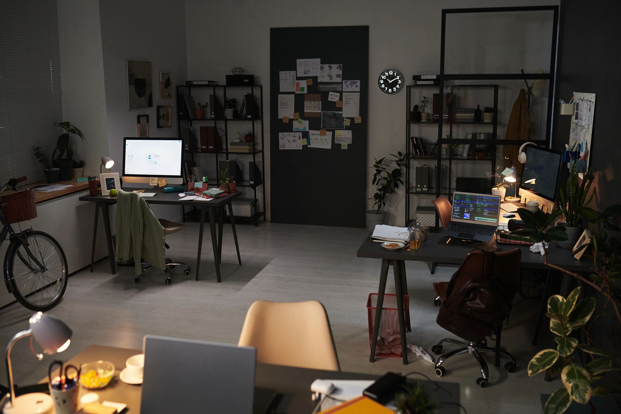 Modern office workspace with desktop computers and laptop